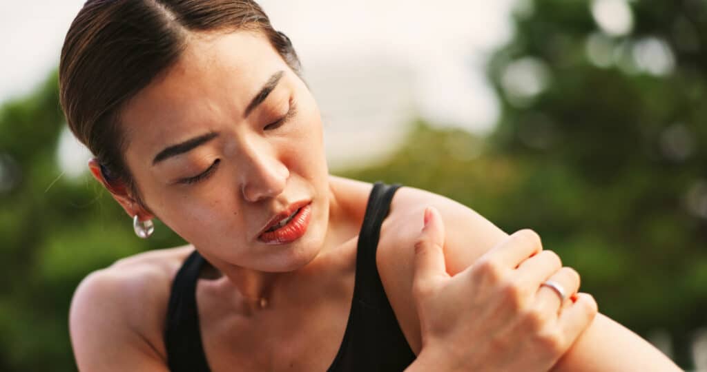 Woman with chronic pain on her shoulder.