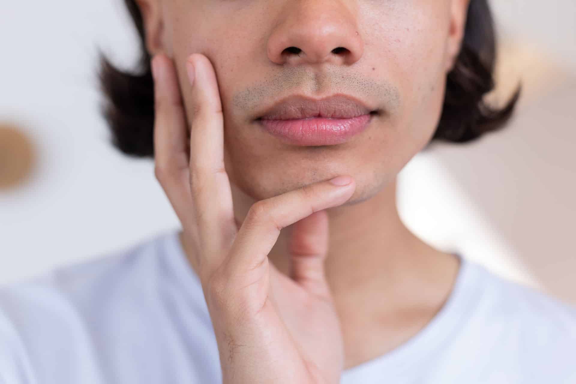 Man holding his face.